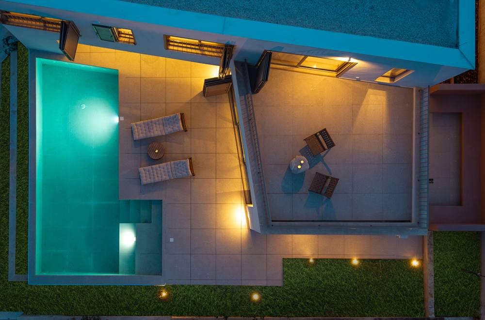 The pool and terraces seen from above at night