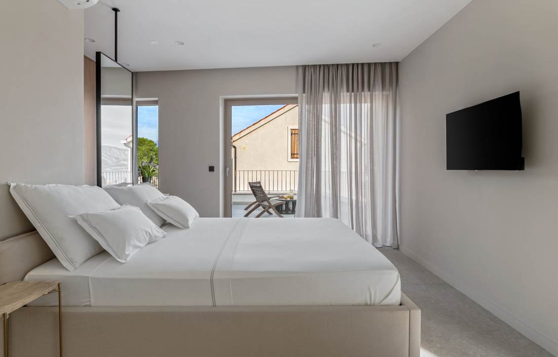 Bedroom with TV and balcony